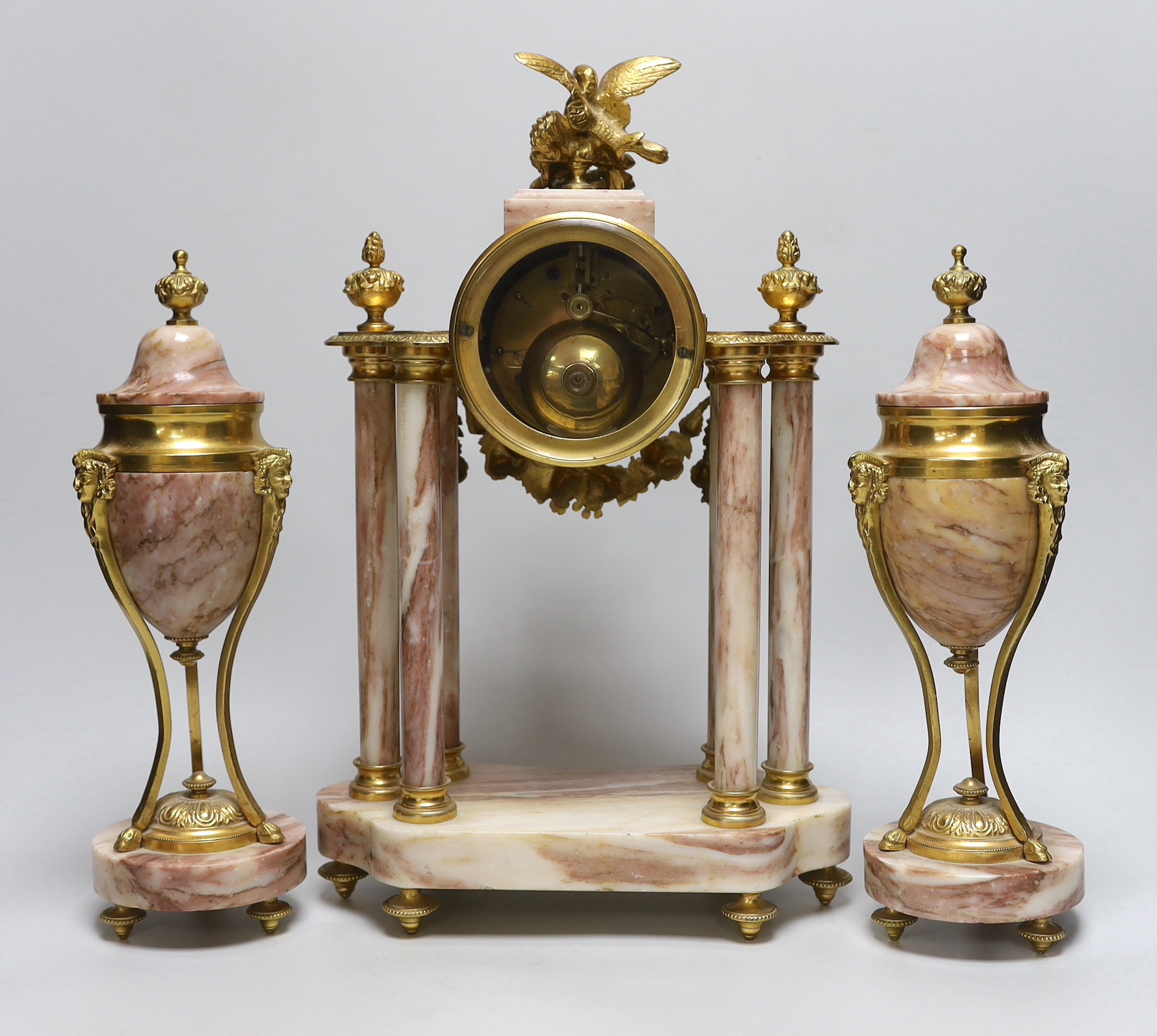 An early 20th century French gilt-metal and marble clock garniture, 38cm high
